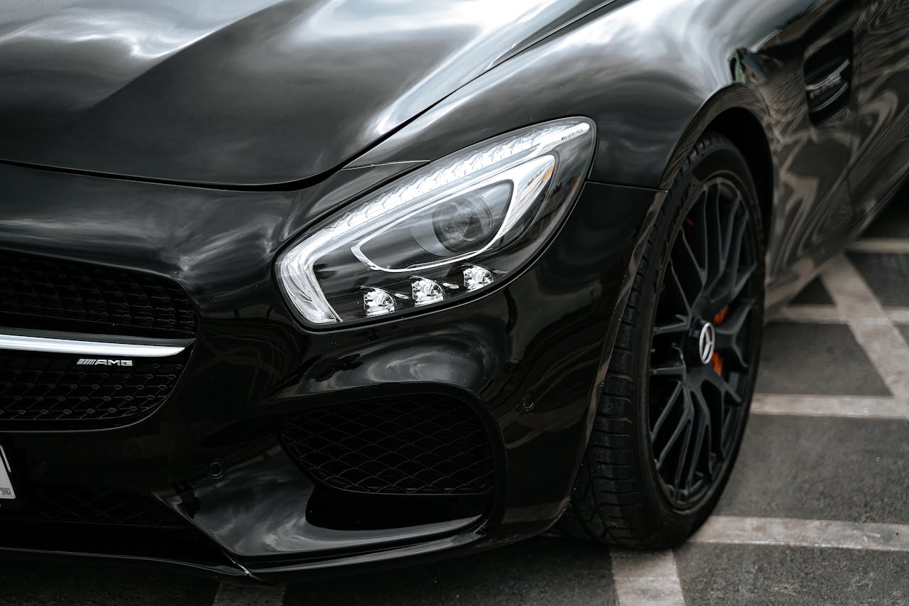 Close-up of a luxury black car showcasing its modern design and detailing.